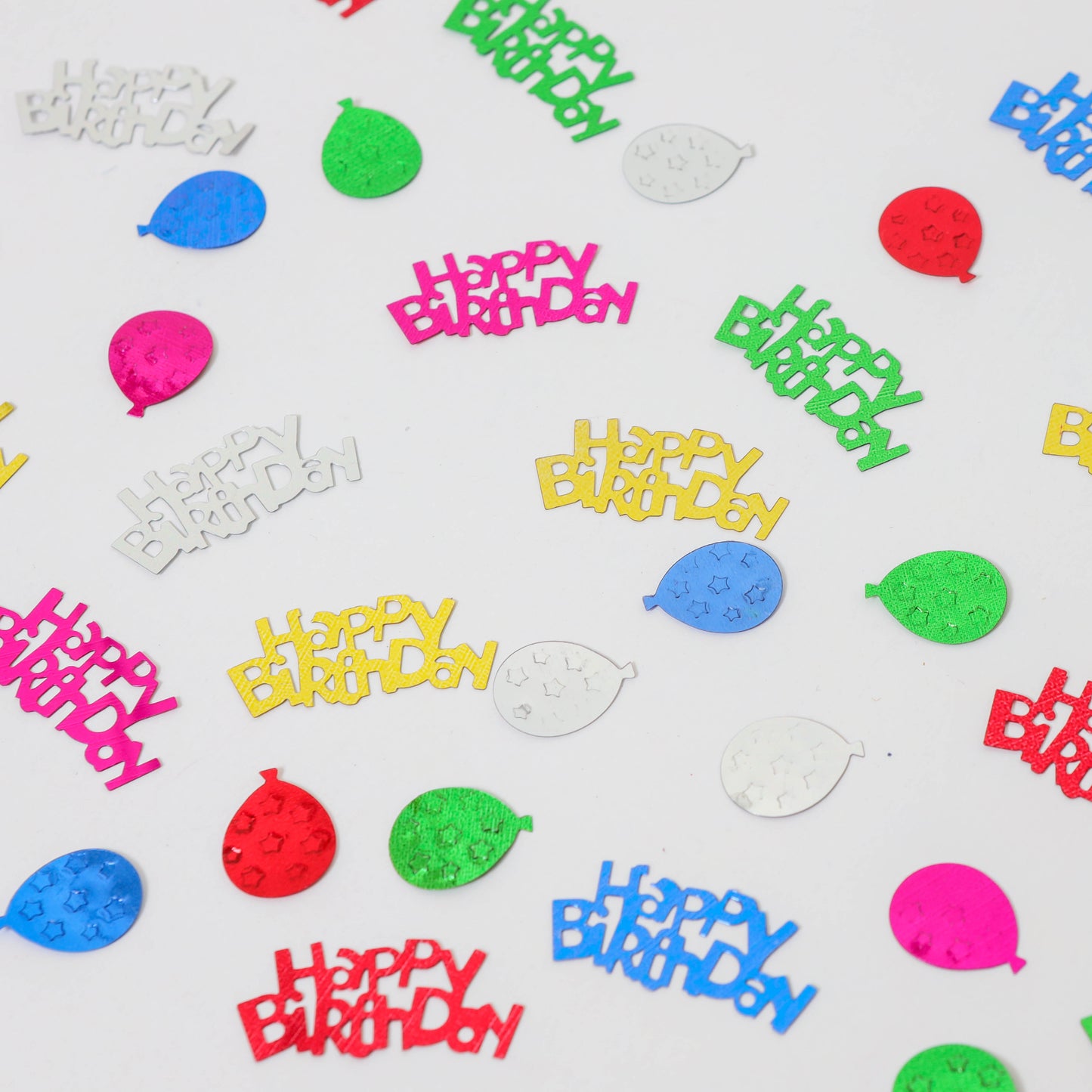 Assorted metallic Happy Birthday confetti and balloon shapes in mixed colors on a white background.