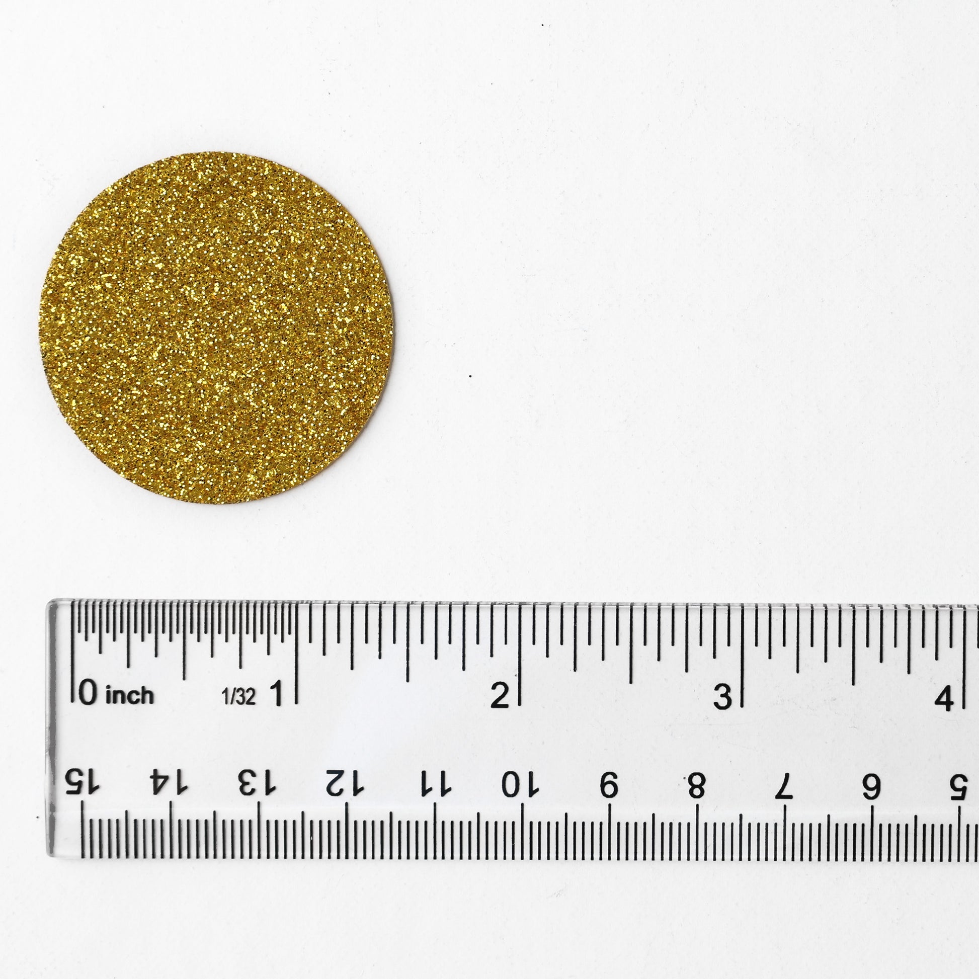 Luxe gold circle confetti with glitter finish shown next to a ruler for size reference
