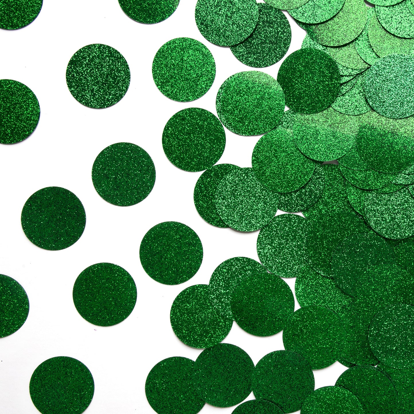 Luxe green circle confetti scattered on a white background with an overlapping pile along the side