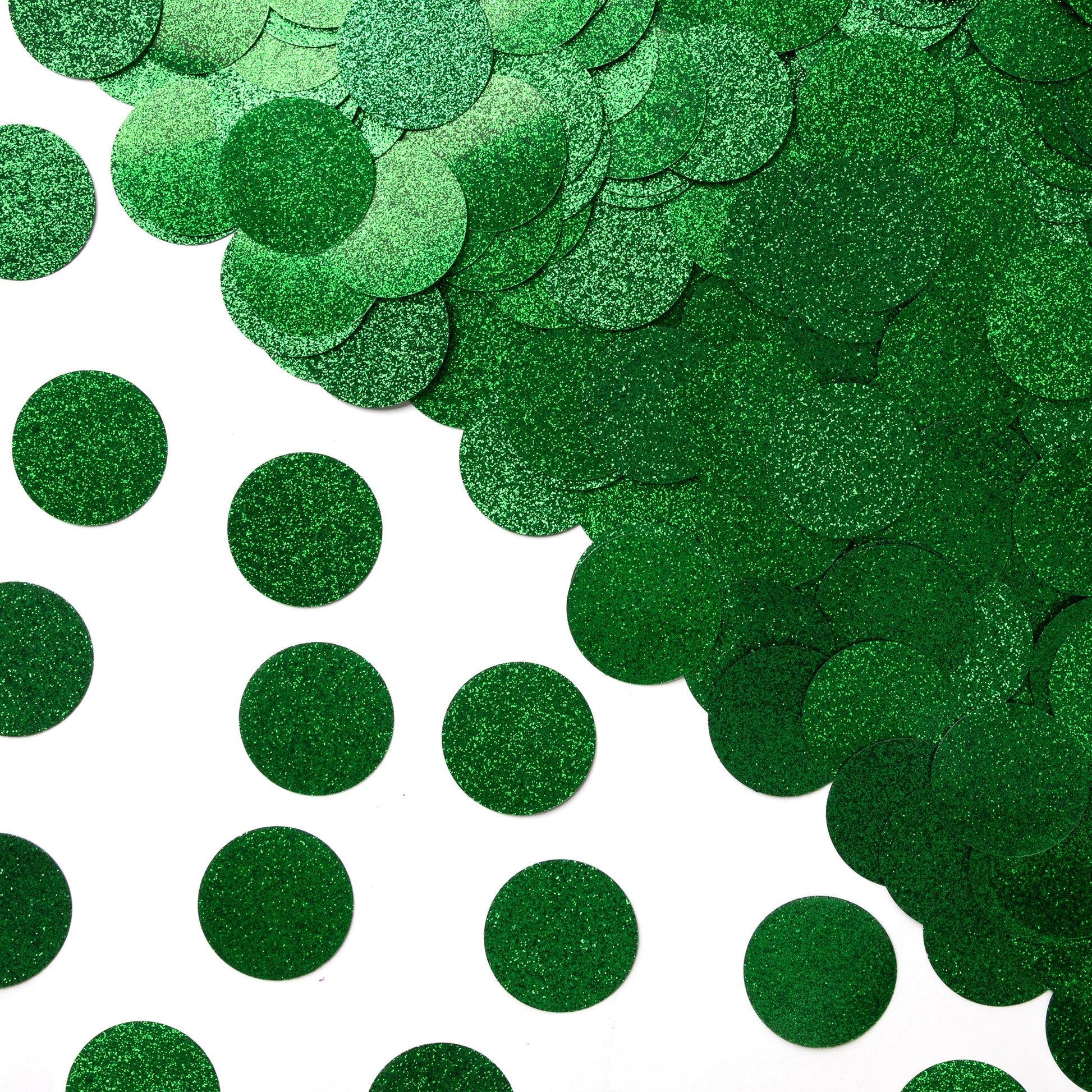 Luxe green circle confetti scattered on a white background with a large pile gathered in the corner