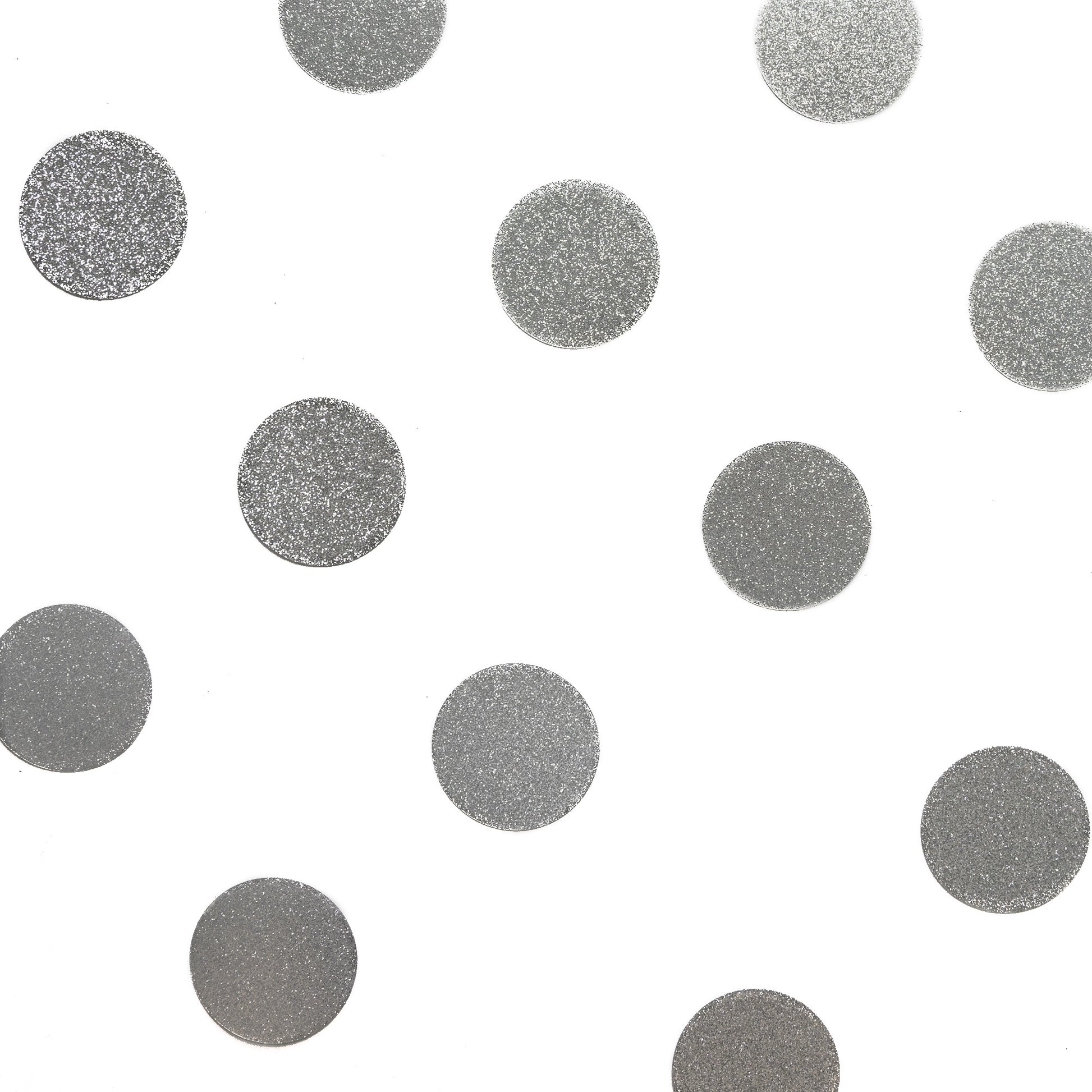 Luxe metallic silver confetti dots arranged on a white background