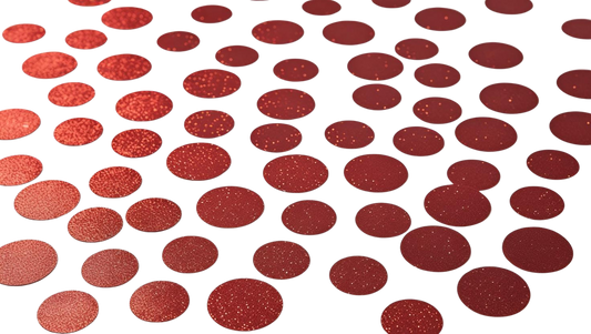Luxe red glitter circle confetti scattered on white background