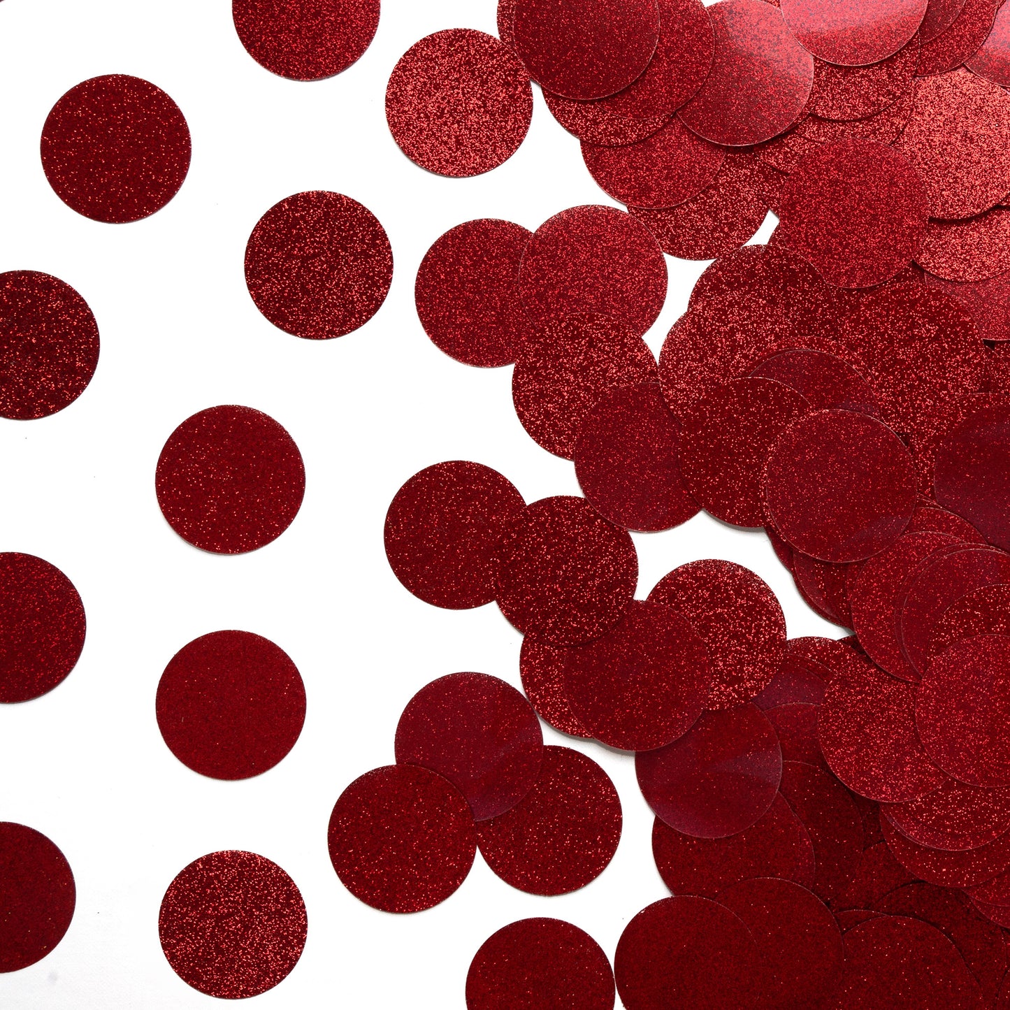 Luxe red glitter circle confetti scattered across a white background on one side