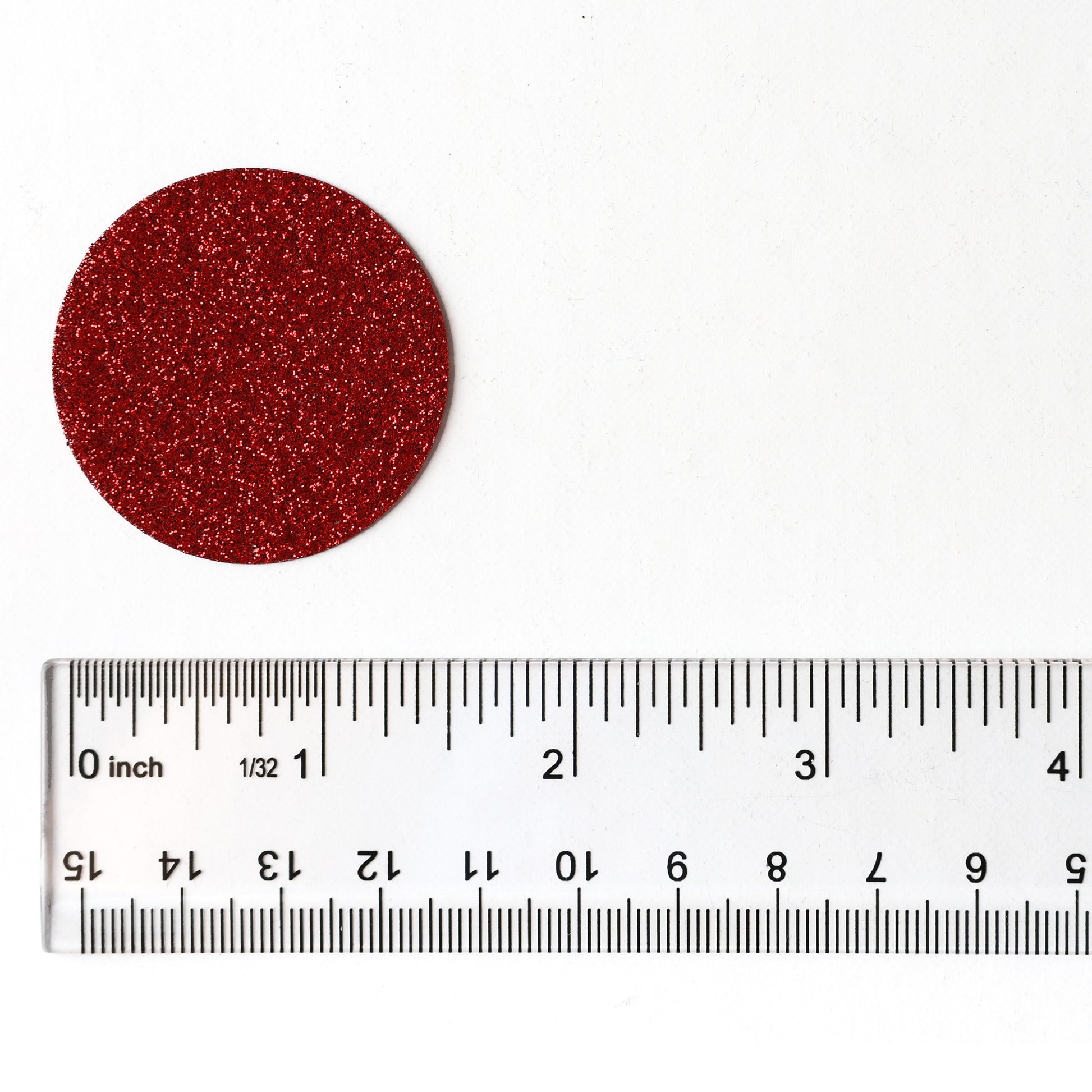 Luxe red glitter circle confetti shown beside a ruler for size reference
