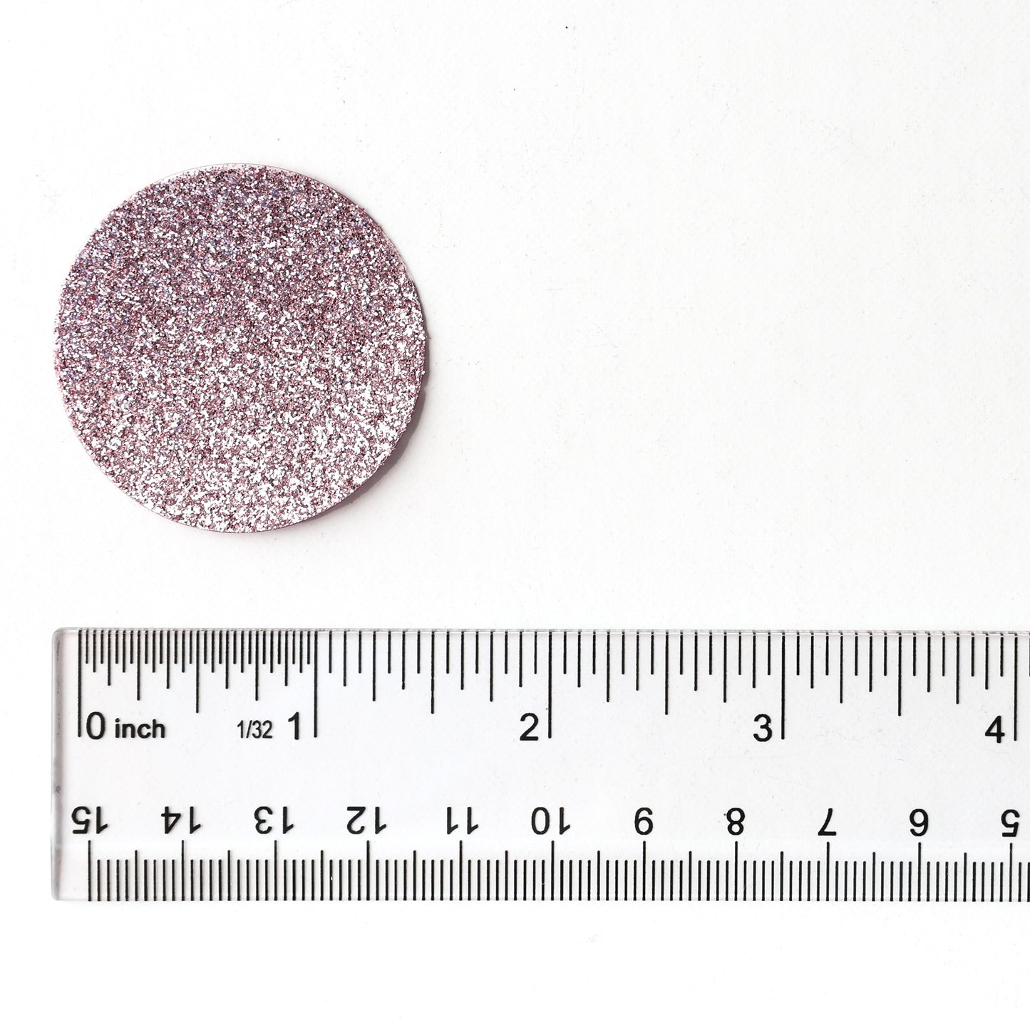 Luxe rose gold glitter circle confetti shown next to a ruler for size reference