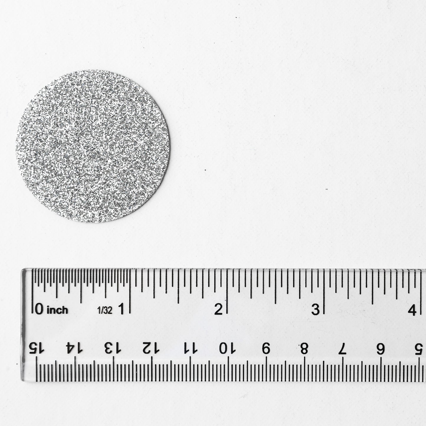 Luxe silver circle confetti shown next to a ruler for size reference on a white background