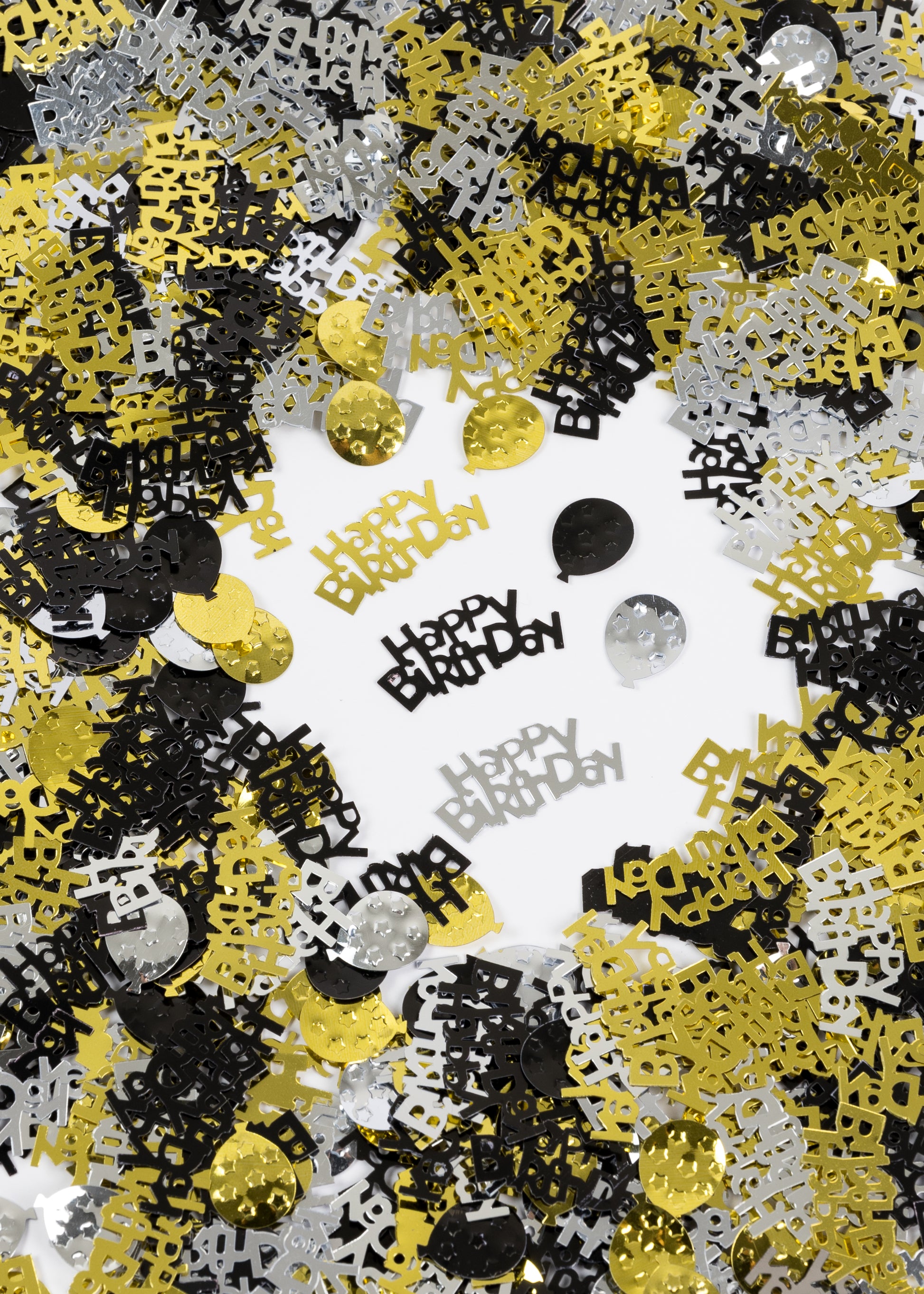 Metallic Happy Birthday confetti in black, gold, and silver scattered on a white background