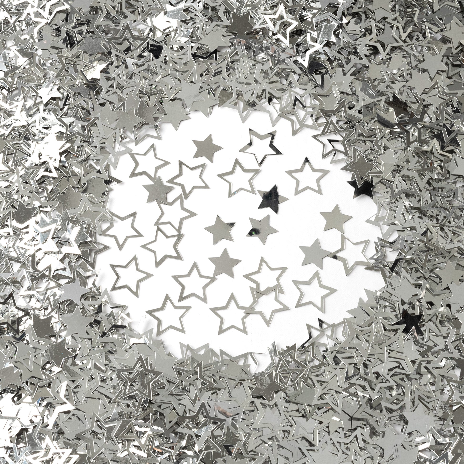 Metallic silver star confetti in mixed hollow and solid shapes arranged on a white background